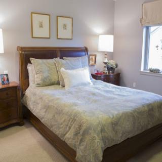 A cozy and elegantly styled bedroom featuring a comfortable bed and soft lighting.