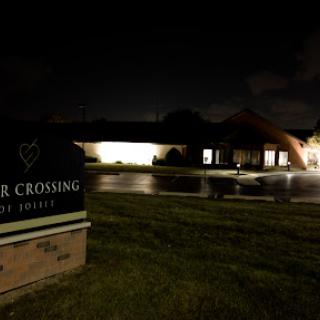 A nighttime view of a community center with illuminated signage.