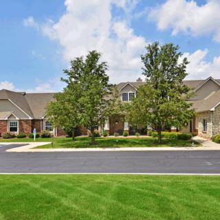 A suburban residential property with well-maintained landscaping and a two-story house.