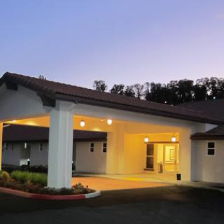 A welcoming entrance of a hotel or inn illuminated at dusk.
