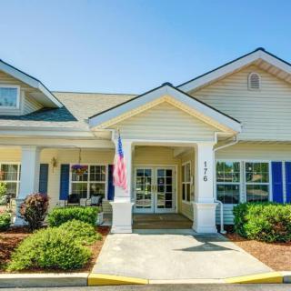 A well-maintained residential building with a welcoming entrance and landscaped surroundings.