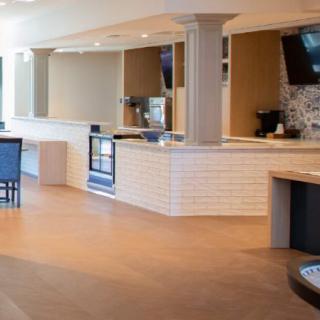 A modern and bright cafe interior with a counter and seating area.