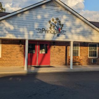 A welcoming entrance to a community-oriented building with a vibrant logo.