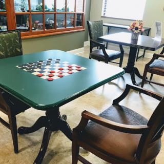 A cozy lounge area featuring game tables with checkerboard designs.