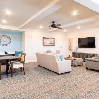 A modern, spacious living room with comfortable seating, a dining area, and stylish decor.