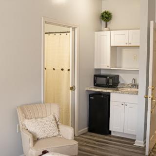 A cozy living space featuring a small kitchenette and comfortable seating.