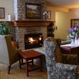 A cozy living room with a welcoming fireplace and comfortable seating.