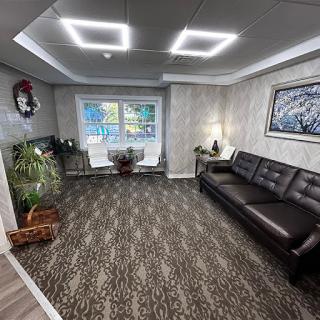 A modern and inviting waiting room featuring sleek furniture and natural elements.