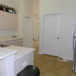 A modern kitchen interior featuring cabinets, countertops, and a refrigerator.