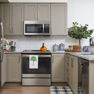 A modern kitchen with stainless steel appliances and elegant decor.