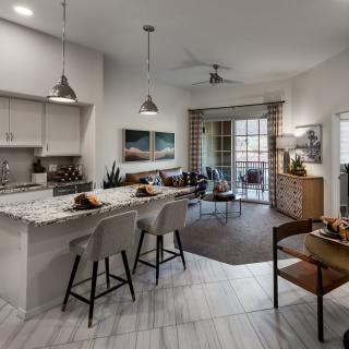 A modern open-concept kitchen and living room with stylish interior design elements.