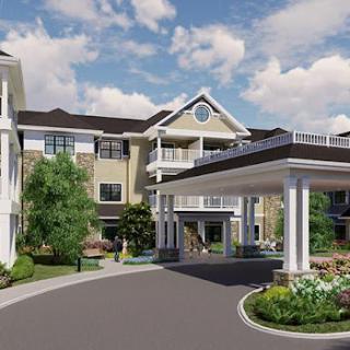A modern residential building featuring a welcoming entrance and landscaped gardens.