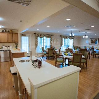 A modern open kitchen and dining area with ample seating and bright lighting.