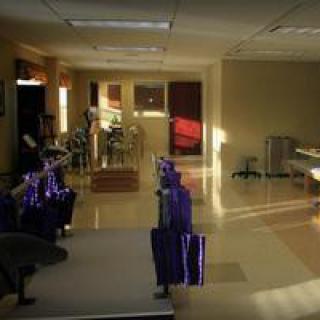 A gym interior with exercise equipment such as treadmills and machines.