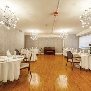 A beautifully designed dining area featuring elegant tables and chandeliers.