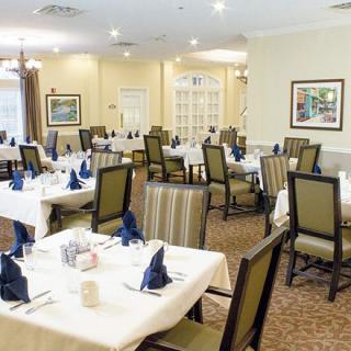 An elegant dining room with neatly arranged tables and chairs, ready for guests.