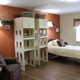A cozy and modern bedroom featuring stylish shelving and an inviting color scheme.