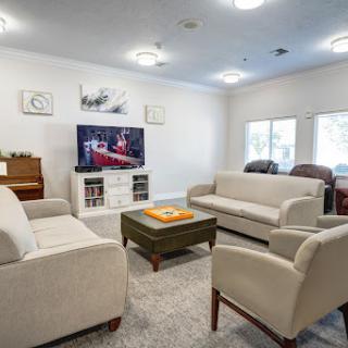 A cozy and inviting living room setup with comfortable sofas, a coffee table, and a television.