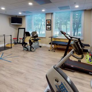 A rehabilitation gym equipped with exercise machines and therapy tools.