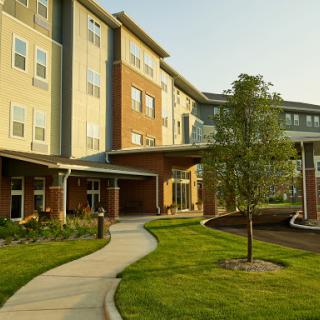 A modern apartment building surrounded by landscaped grounds.