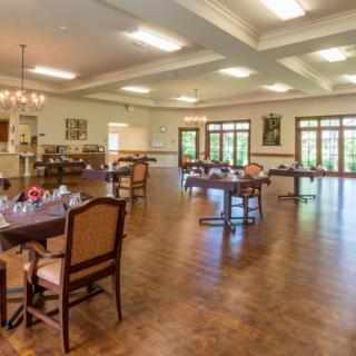 Spacious dining area with elegant furnishings and natural lighting.