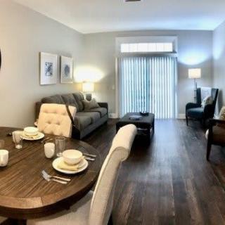 A cozy living and dining area with modern furniture and decor.