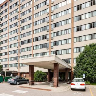 A multi-story residential building with a covered entrance.
