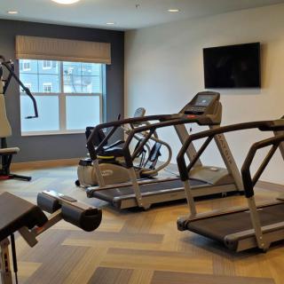 A modern gym with treadmills and exercise machines.