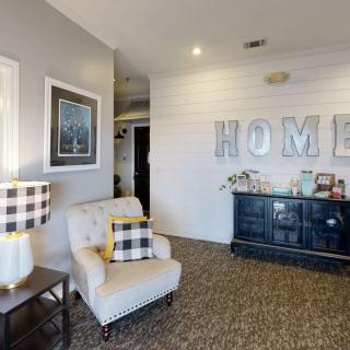 A cozy living room with a comfortable armchair and decorative accents, creating a welcoming atmosphere.