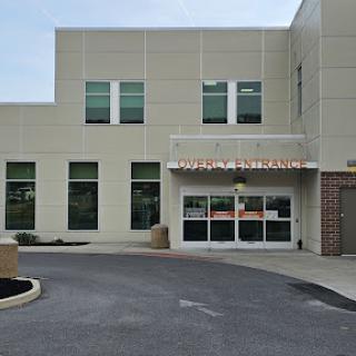 A modern commercial building with large windows and an accessible entrance.