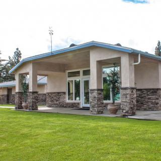 A modern residential house with a well-maintained lawn and an elegant design.