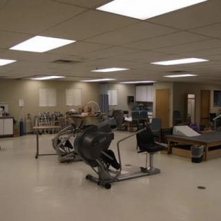 An indoor gym area featuring exercise equipment such as stationary bikes.