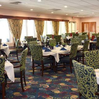 An elegant restaurant dining room with neatly arranged tables and chairs.