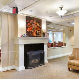 A cozy lobby interior featuring a fireplace and comfortable seating.