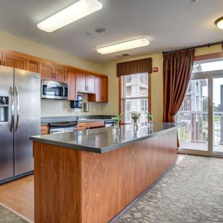 A modern kitchen with stainless steel appliances and a spacious island.
