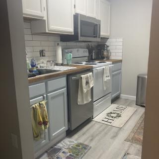 A modern kitchen with stainless steel appliances and a cozy atmosphere.
