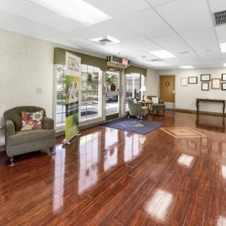 A spacious and inviting lobby featuring elegant wooden flooring and comfortable seating.