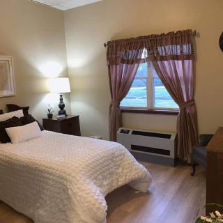 Cozy bedroom with a single bed and wooden furniture.