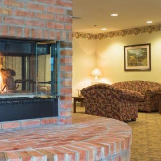 A cozy living room with a brick fireplace and comfortable seating.