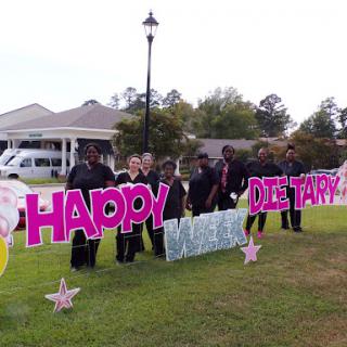 A cheerful birthday celebration with a colorful sign welcoming the guest of honor.