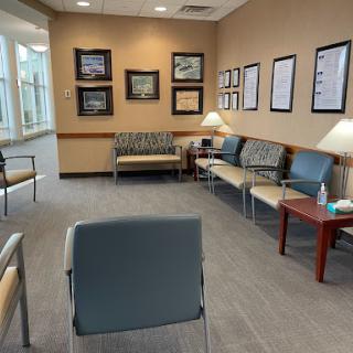 A welcoming waiting room with comfortable seating and soft lighting, designed for patient comfort.