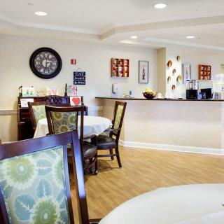 A cozy dining area with neatly set tables and comfortable seating.