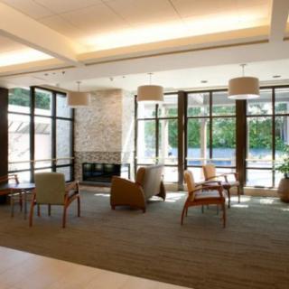 A modern lobby with comfortable seating and large windows allowing plenty of natural light.