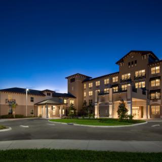 A beautifully lit hotel building at night.