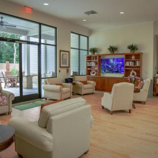 A modern living room with comfortable seating and a large TV.