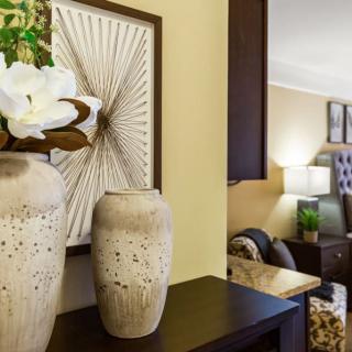 A stylishly decorated living room featuring elegant vases and artwork.