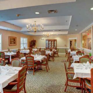 An elegant dining room with neatly arranged tables and chairs, ready for guests.