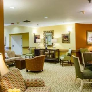 A cozy lounge area featuring comfortable seating and warm lighting.