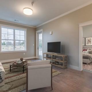 A cozy living room with modern furniture and ample natural light.