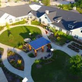 Aerial view of a building with landscaped gardens and pathways.